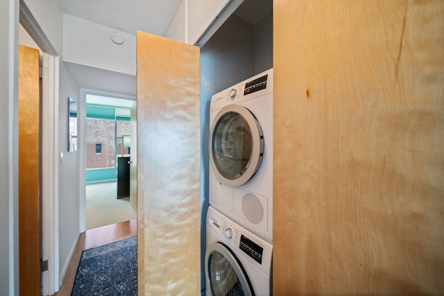3200 N Lake Shore Dr Unit 911, Chicago, IL 60657 - washroom featuring stacked washer and clothes dryer and wood finished floors