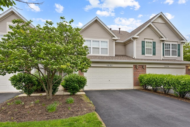 3092 Serenity Ln, Naperville, IL 60564 - multi unit property featuring driveway, brick siding, roof with shingles, and a garage