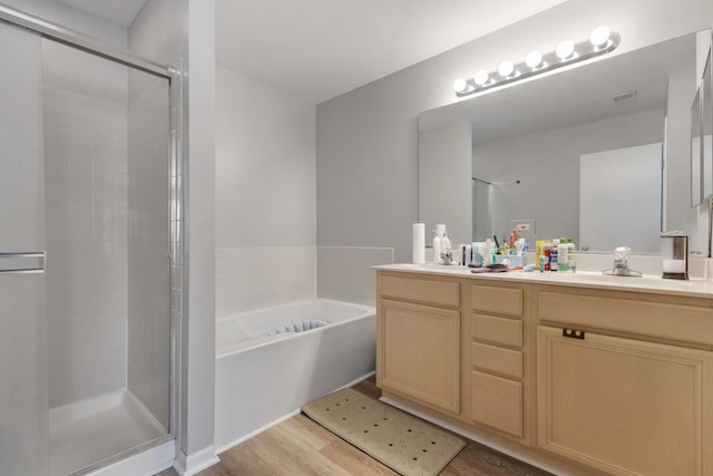 3092 Serenity Ln, Naperville, IL 60564 - full bathroom with wood finished floors, double vanity, a shower stall, and a garden tub