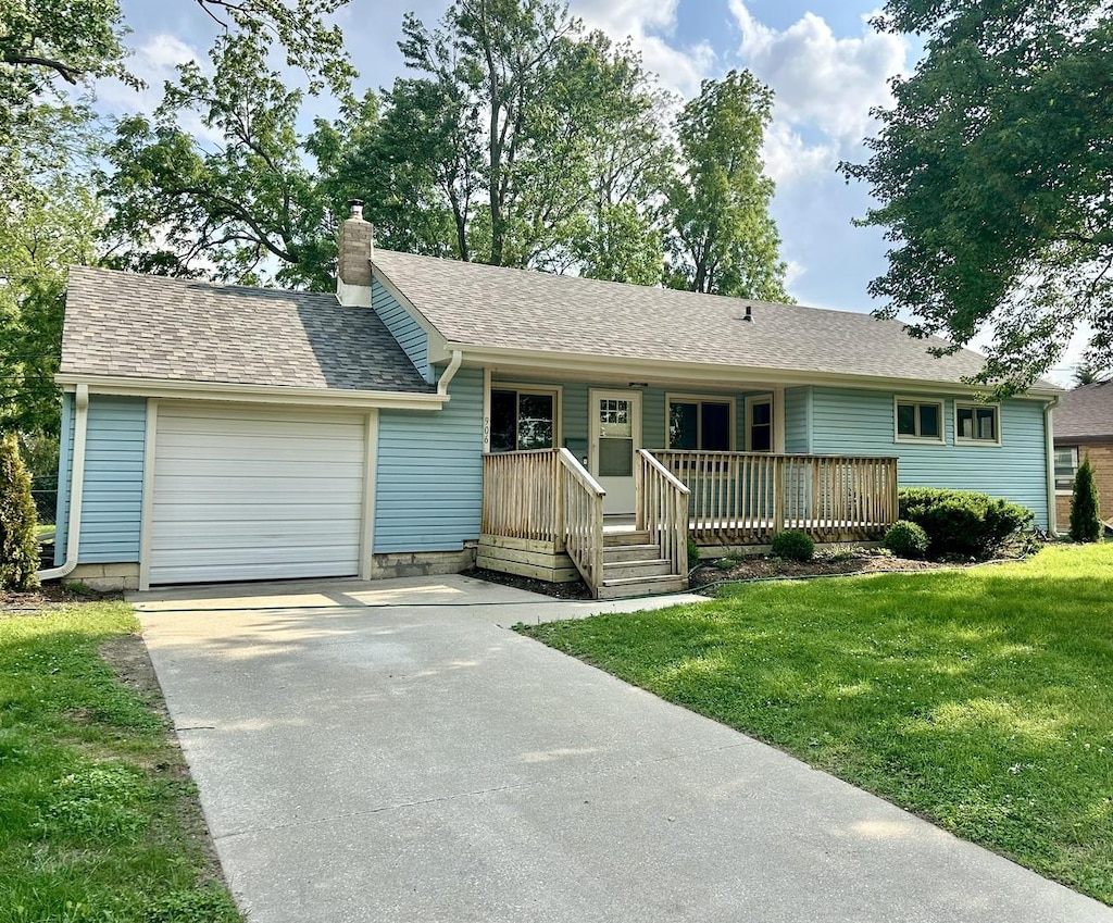 906 W Walnut St, Kankakee, IL 60901 - single story home featuring a porch, driveway, a garage, a front lawn, and a chimney