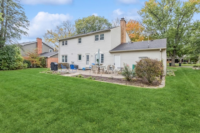 961 N Arrowhead Dr, Palatine, IL 60074 - back of property with a chimney, a lawn, and a patio area