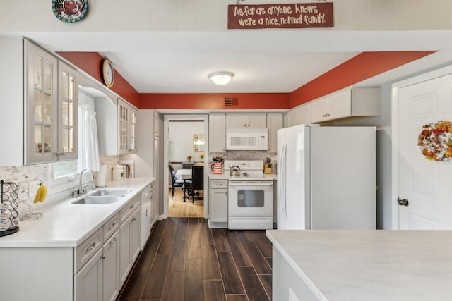 961 N Arrowhead Dr, Palatine, IL 60074 - kitchen featuring white appliances, a sink, dark wood-style floors, backsplash, and light countertops