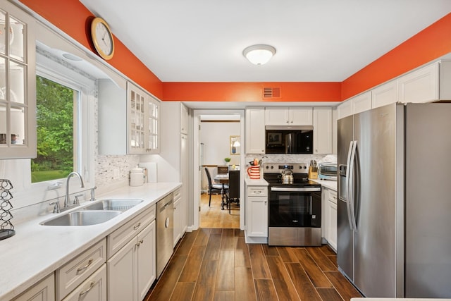 961 N Arrowhead Dr, Palatine, IL 60074 - kitchen featuring appliances with stainless steel finishes, white cabinetry, light countertops, backsplash, and dark wood-type flooring