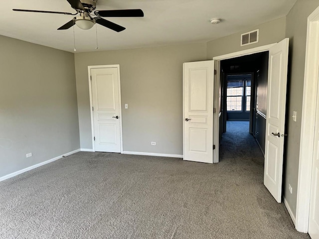 3292 Bromley Ln, Aurora, IL 60502 - spare room featuring dark carpet, ceiling fan, a smoke detector, and baseboards