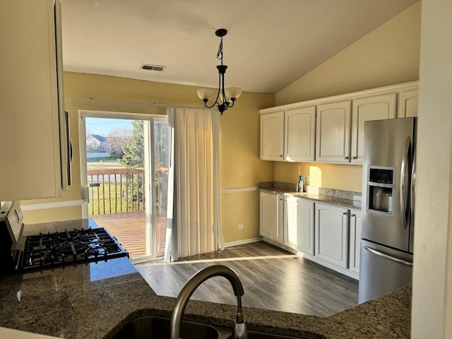 3292 Bromley Ln, Aurora, IL 60502 - kitchen with stainless steel fridge with ice dispenser, white cabinets, vaulted ceiling, dark wood-style flooring, and stone counters
