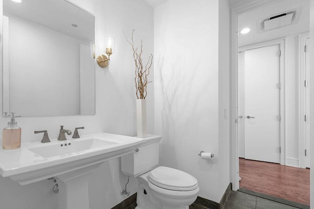 401 N Wabash Ave Unit 42E, Chicago, IL 60611 - half bathroom featuring toilet, a sink, recessed lighting, and baseboards