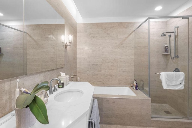 401 N Wabash Ave Unit 42E, Chicago, IL 60611 - full bathroom with tile walls, a shower stall, a bath, and vanity