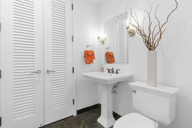 401 N Wabash Ave Unit 42E, Chicago, IL 60611 - bathroom with a closet, toilet, stone finish floors, and baseboards