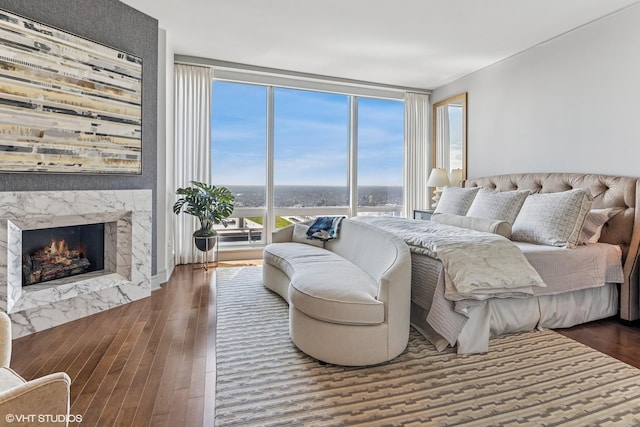 401 N Wabash Ave Unit 54E, Chicago, IL 60611 - bedroom with a premium fireplace, wood finished floors, and floor to ceiling windows