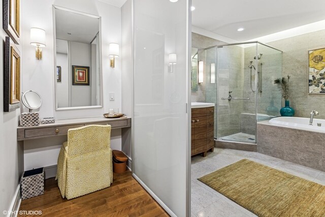 401 N Wabash Ave Unit 54E, Chicago, IL 60611 - bathroom with a stall shower, a garden tub, vanity, and recessed lighting