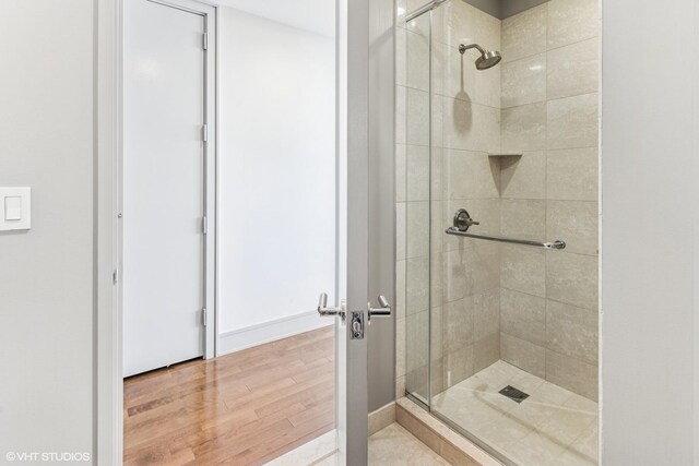 401 N Wabash Ave Unit 54E, Chicago, IL 60611 - full bathroom featuring a stall shower, wood finished floors, and baseboards