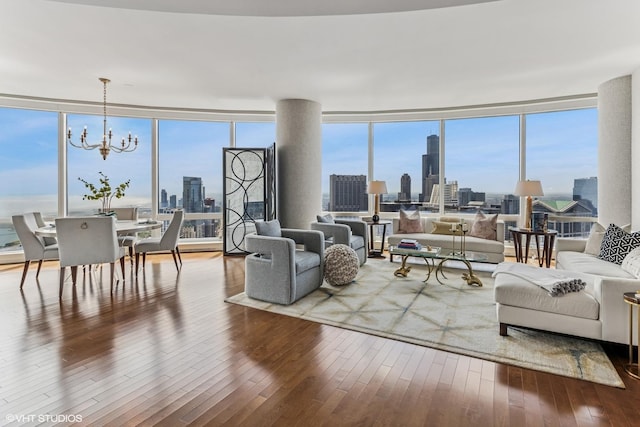 401 N Wabash Ave Unit 54E, Chicago, IL 60611 - living room featuring a view of skyline, a chandelier, wood-type flooring, and plenty of natural light