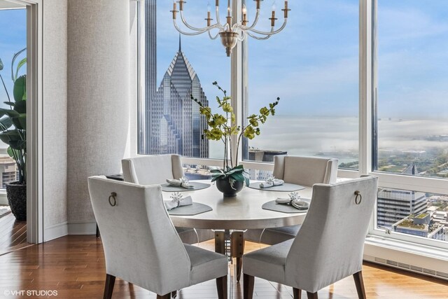 401 N Wabash Ave Unit 54E, Chicago, IL 60611 - dining space with a chandelier, wood finished floors, and baseboards