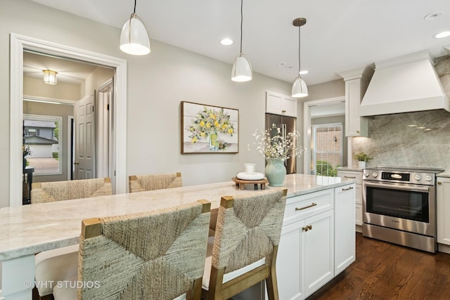 614 S Patton Ave, Arlington Heights, IL 60005 - kitchen with appliances with stainless steel finishes, custom range hood, backsplash, a breakfast bar, and light stone counters