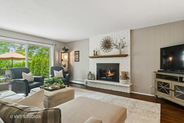 614 S Patton Ave, Arlington Heights, IL 60005 - living area featuring dark wood finished floors, baseboard heating, a brick fireplace, and baseboards
