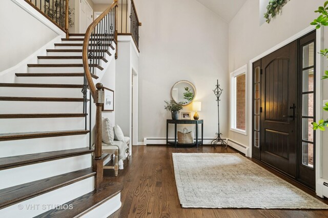 614 S Patton Ave, Arlington Heights, IL 60005 - foyer entrance featuring high vaulted ceiling, stairs, wood finished floors, baseboards, and a baseboard heating unit