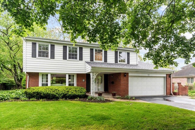 1025 Oxford Rd, Deerfield, IL 60015 - view of front of property featuring asphalt driveway, a garage, a front yard, and brick siding
