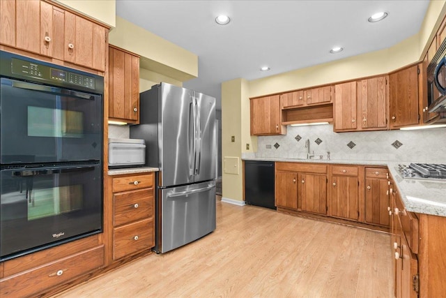 1025 Oxford Rd, Deerfield, IL 60015 - kitchen with black appliances, a sink, light wood-style floors, backsplash, and brown cabinetry