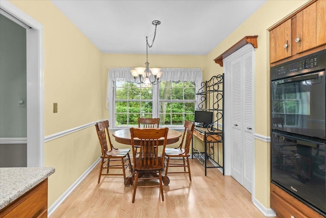 1025 Oxford Rd, Deerfield, IL 60015 - dining space featuring light wood-style floors, a chandelier, and baseboards