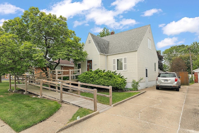 18122 Wentworth Ave, Lansing, IL 60438 - view of front of property featuring roof with shingles, a chimney, and concrete driveway