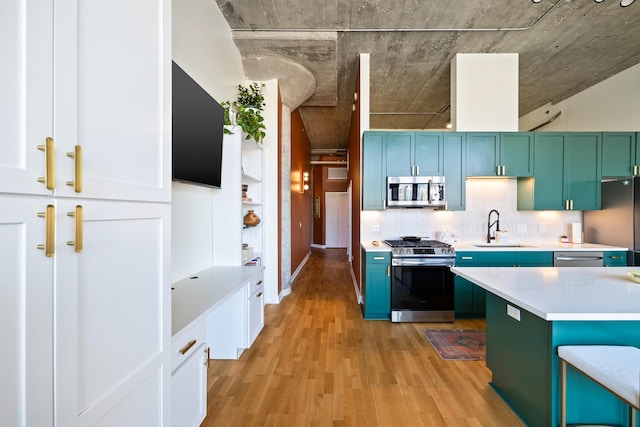 320 E 21st St Unit 402, Chicago, IL 60616 - kitchen featuring stainless steel appliances, a sink, light wood-style flooring, and light countertops