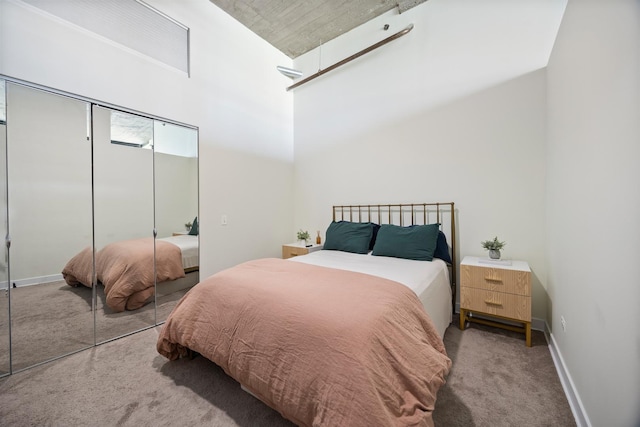 320 E 21st St Unit 402, Chicago, IL 60616 - carpeted bedroom featuring a closet, baseboards, and a towering ceiling