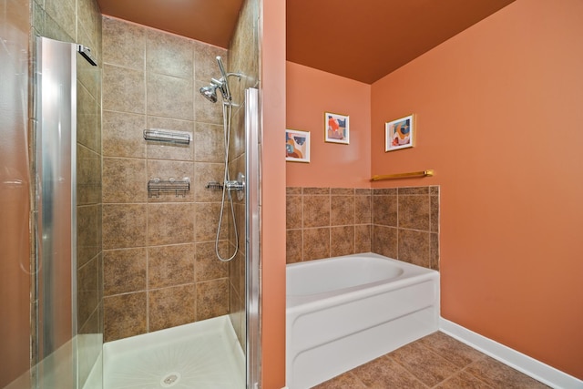 320 E 21st St Unit 402, Chicago, IL 60616 - bathroom with a stall shower, a garden tub, tile patterned flooring, and baseboards
