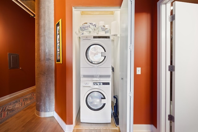 320 E 21st St Unit 402, Chicago, IL 60616 - washroom with stacked washer and clothes dryer, wood finished floors, and baseboards