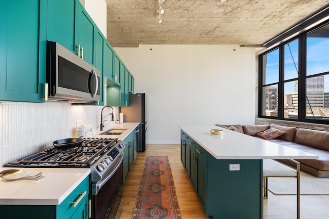 320 E 21st St Unit 402, Chicago, IL 60616 - kitchen featuring stainless steel appliances, a sink, wood finished floors, a kitchen island, and decorative backsplash
