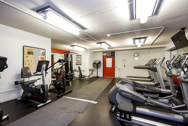 1700 E 56th St Unit 904, Chicago, IL 60637 - exercise room with a textured ceiling
