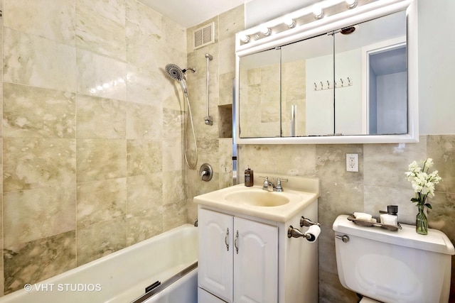 1700 E 56th St Unit 904, Chicago, IL 60637 - bathroom with bathing tub / shower combination, toilet, vanity, tile walls, and decorative backsplash