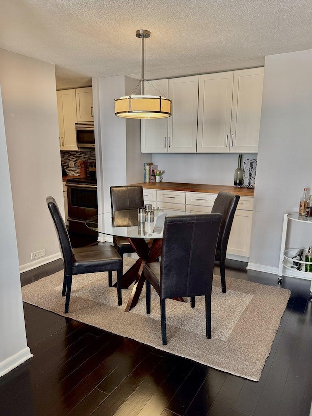 2740 N Pine Grove Ave Unit 9B, Chicago, IL 60614 - dining room with baseboards, dark wood-type flooring, and a textured ceiling