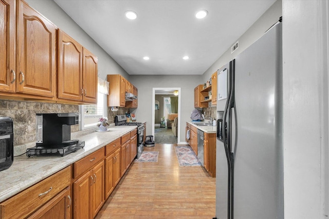 509 S Main St, Homer, IL 61849 - kitchen featuring appliances with stainless steel finishes, backsplash, light wood finished floors, recessed lighting, and a sink