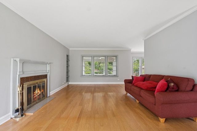 2109 Cummings Ln, Flossmoor, IL 60422 - living area with light wood finished floors, a glass covered fireplace, ornamental molding, built in shelves, and baseboards