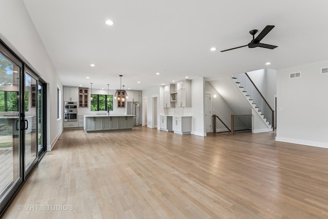 1527 N Louise Ln, Palatine, IL 60067 - unfurnished living room with recessed lighting, light wood-type flooring, a ceiling fan, and stairway
