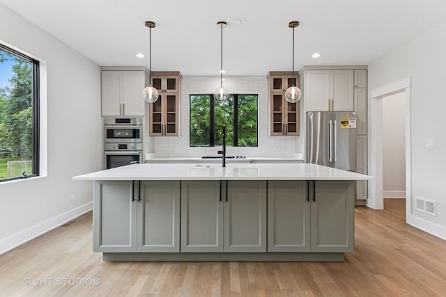 1527 N Louise Ln, Palatine, IL 60067 - kitchen featuring stainless steel appliances, gray cabinetry, a kitchen island with sink, light countertops, and recessed lighting