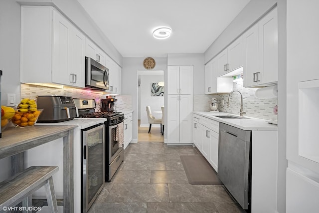 603 Barberry Ln, Wheeling, IL 60090 - kitchen with stainless steel appliances, a sink, backsplash, and white cabinetry