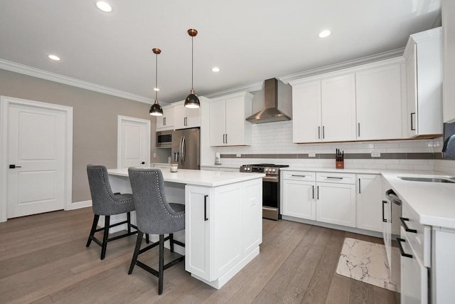 6704 Whisper Glen Dr, Plainfield, IL 60586 - kitchen with wall chimney exhaust hood, appliances with stainless steel finishes, a kitchen island, decorative backsplash, and white cabinetry