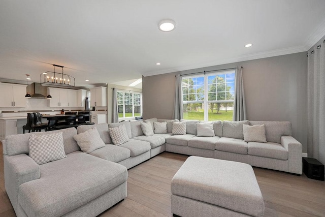 6704 Whisper Glen Dr, Plainfield, IL 60586 - living area with crown molding, light wood finished floors, recessed lighting, and a chandelier