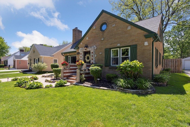 404 Vale Ave N, Rockford, IL 61107 - tudor-style house with a chimney, brick siding, and a front lawn
