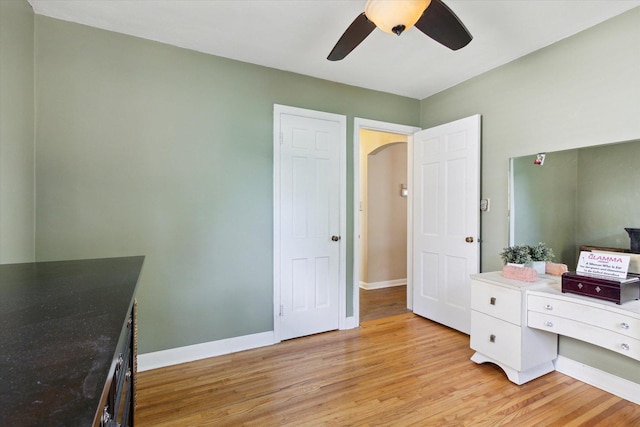 404 Vale Ave N, Rockford, IL 61107 - bedroom featuring light wood finished floors, baseboards, a ceiling fan, and arched walkways