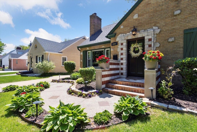 404 Vale Ave N, Rockford, IL 61107 - doorway to property featuring a chimney and stone siding