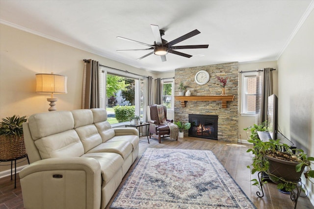 404 Vale Ave N, Rockford, IL 61107 - living area with ceiling fan, a stone fireplace, crown molding, wood finished floors, and baseboards