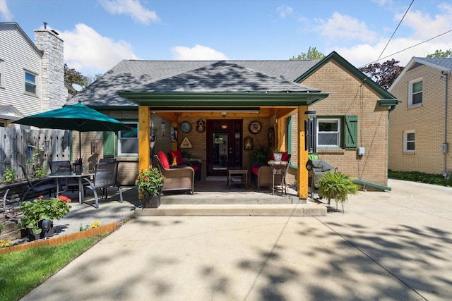 404 Vale Ave N, Rockford, IL 61107 - property entrance with brick siding, a shingled roof, and a porch