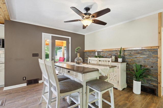404 Vale Ave N, Rockford, IL 61107 - dining area featuring wood finished floors, a ceiling fan, crown molding, and baseboards