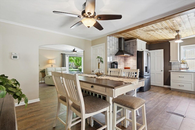 404 Vale Ave N, Rockford, IL 61107 - dining room with a ceiling fan, plenty of natural light, ornamental molding, arched walkways, and wood finished floors