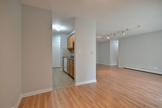 1806 Hemlock Pl Unit 105, Schaumburg, IL 60173 - unfurnished room with a baseboard radiator, light wood-style floors, baseboards, and rail lighting