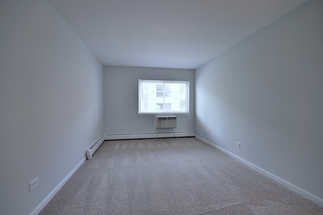 1806 Hemlock Pl Unit 105, Schaumburg, IL 60173 - spare room with an AC wall unit, carpet flooring, a baseboard radiator, and baseboards