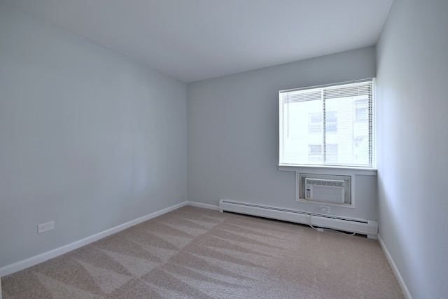 1806 Hemlock Pl Unit 105, Schaumburg, IL 60173 - spare room featuring a baseboard radiator, light carpet, baseboards, and a wall mounted AC
