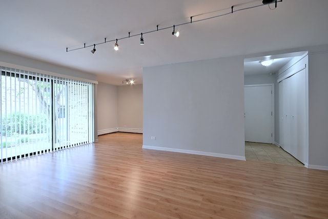 1806 Hemlock Pl Unit 105, Schaumburg, IL 60173 - spare room featuring light wood-style floors, baseboards, and track lighting